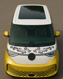 Yellow car with decorative black design on the front, on a brown background