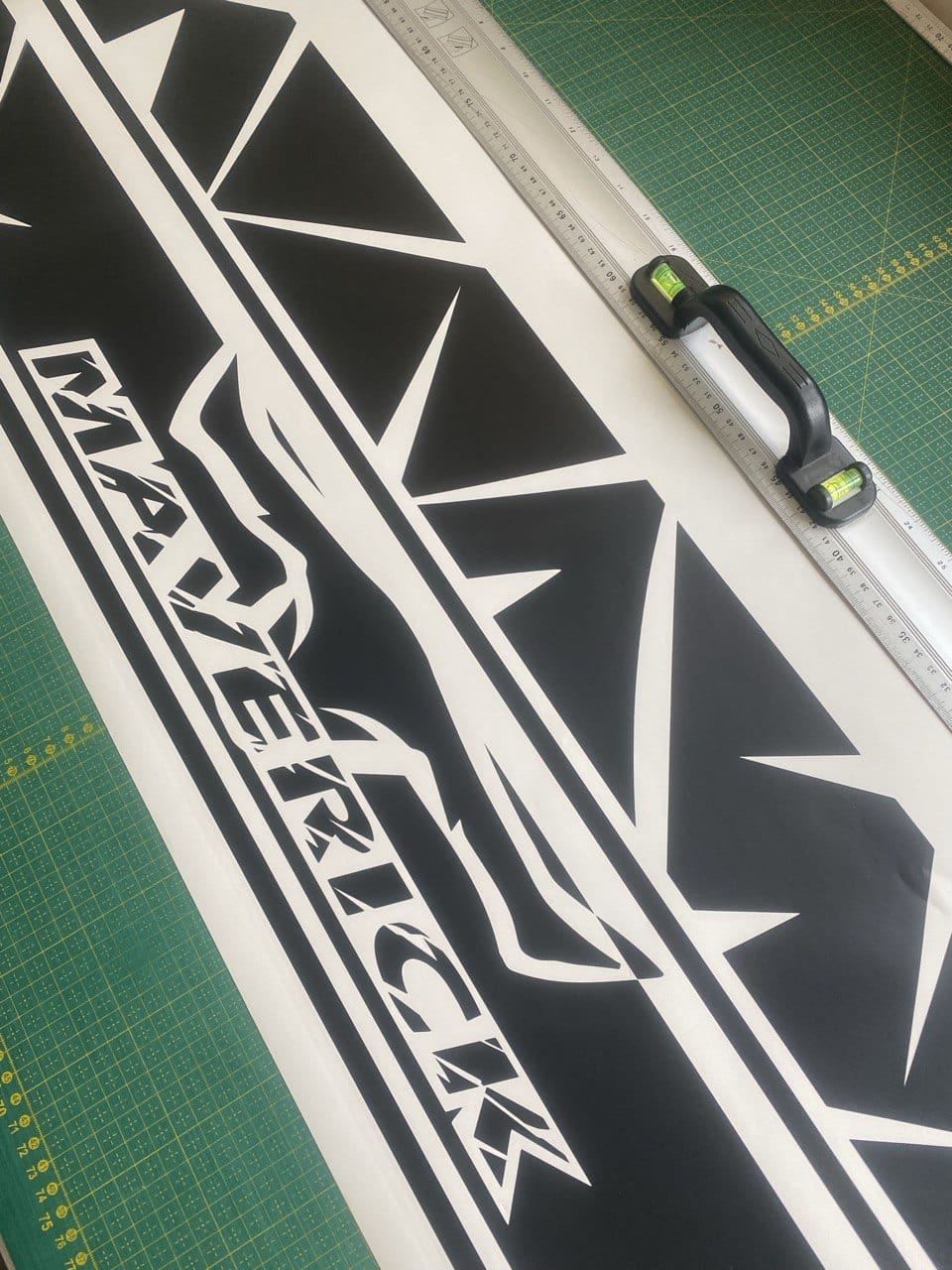 Black and white decal with 'Maverick' branding on a cutting mat.