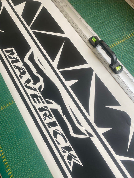 Black and white decal with 'Maverick' branding on a cutting mat.