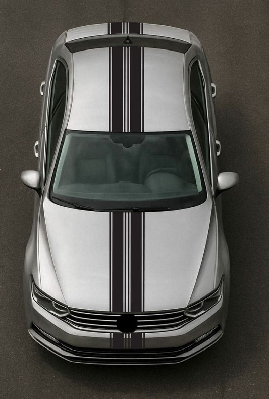 Top-down view of a silver car with black stripes on a dark background
