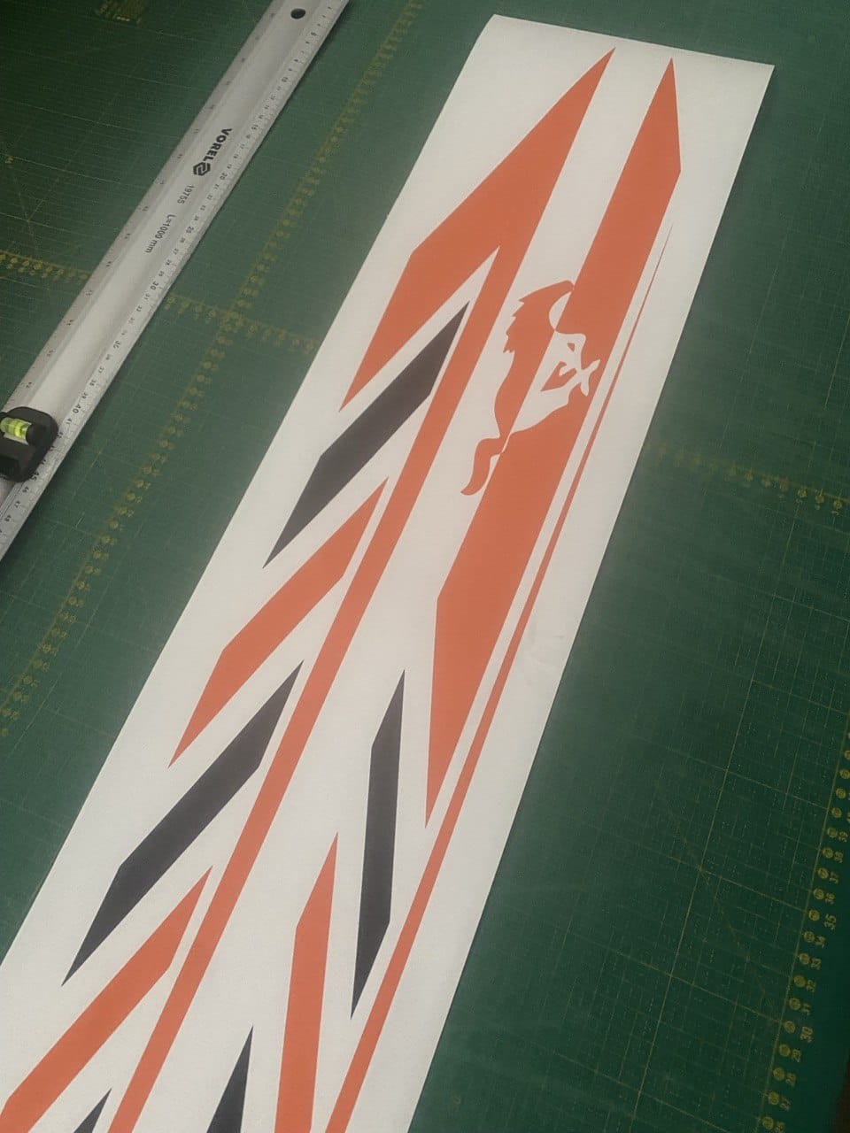 Decorative decal with geometric pattern on a green cutting mat with ruler