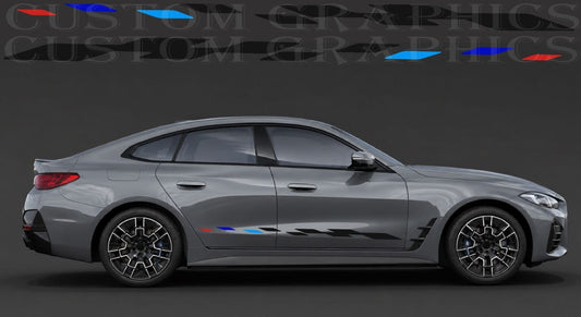A gray BMW sedan shown in side profile on a dark studio background, with decorative blue, red, and black graphic decals applied along the lower side and a faint 'CUSTOM GRAPHICS' watermark across the top.