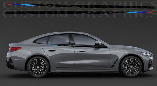 A side profile view of a gray BMW sedan with custom black vinyl graphics and small red and blue accent stripes on the rear and front fenders, set against a dark gray studio background with a faint watermark.