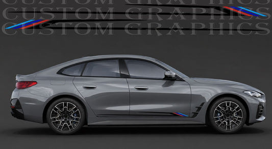 A gray BMW sedan shown in side profile on a dark studio background, with a custom black strip decal applied along the lower side panel. The decal includes thin black stripes and small blue and red accents near the rear wheel arch.