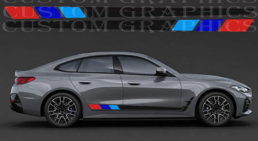 A gray BMW sedan shown in side profile on a dark studio background, with a small blue and red M-style stripe decal applied near the lower side panel. Large 'CUSTOM GRAPHICS' text appears across the top, and a smaller version of the same decal is shown above the car.