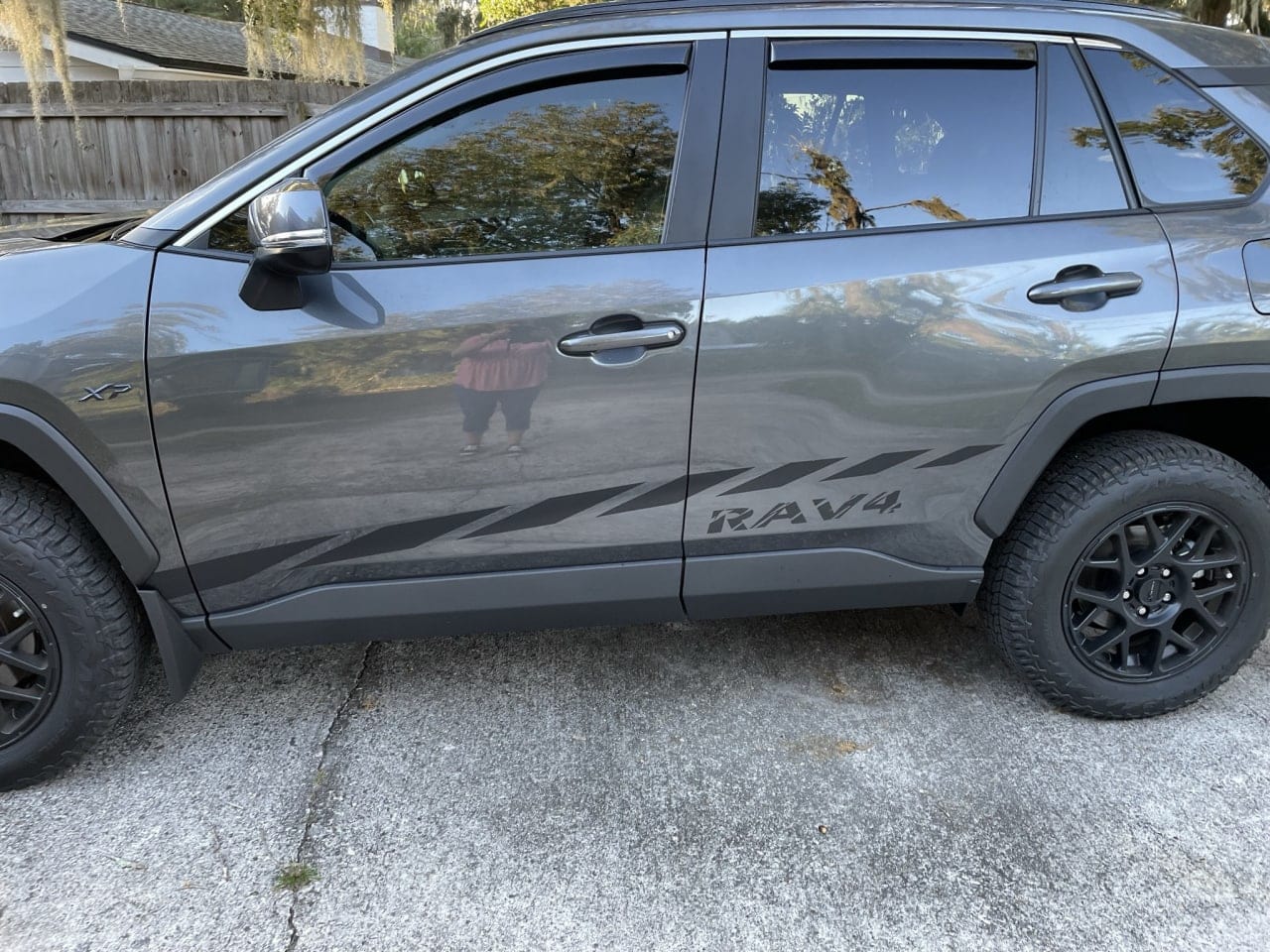 A Toyota RAV4 SUV with a set of black decals featuring a racing stripe design on the side.